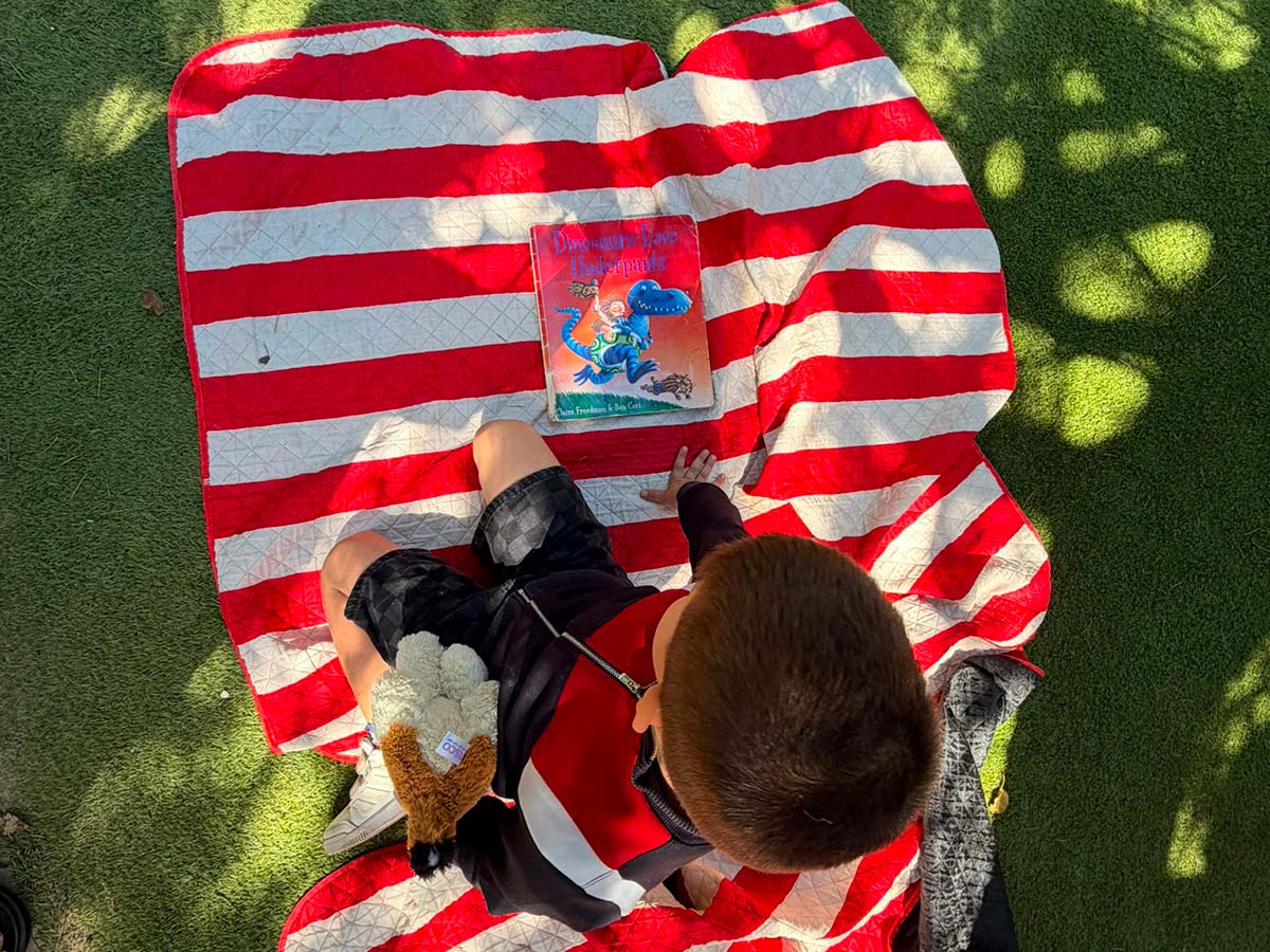 child enjoying reading in nature