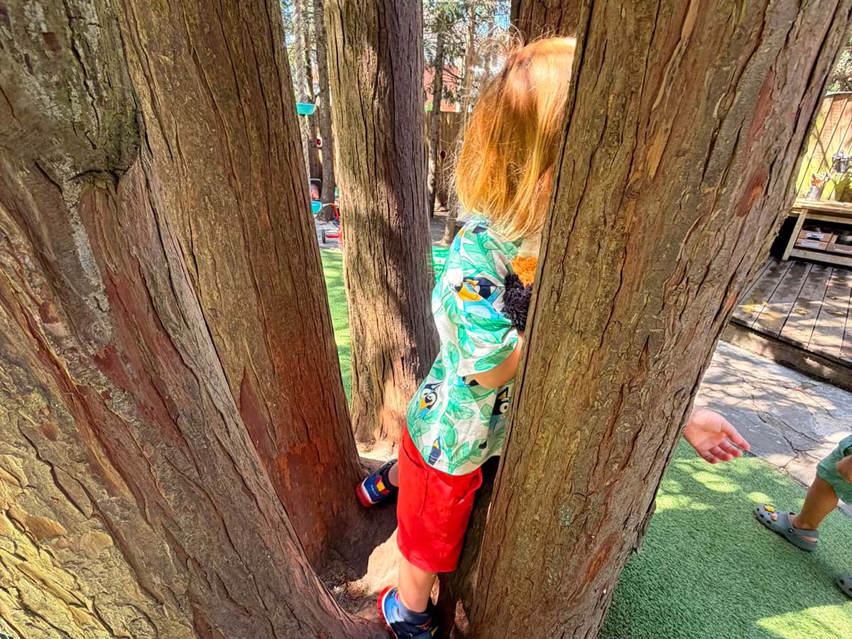 child playing in the woodland garden outdoor learning every day